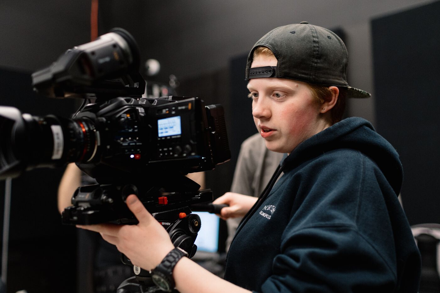 Young Filmmaker Operating Camera