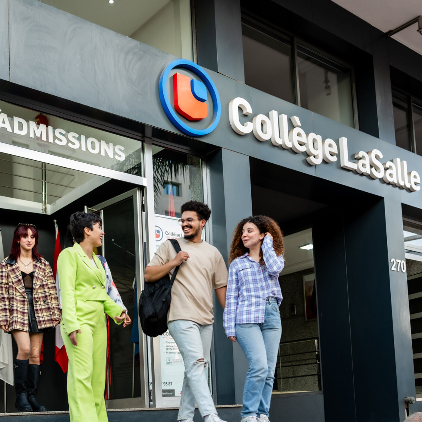 Four diverse students engaging in conversation outside the admissions entrance of Collège LaSalle.