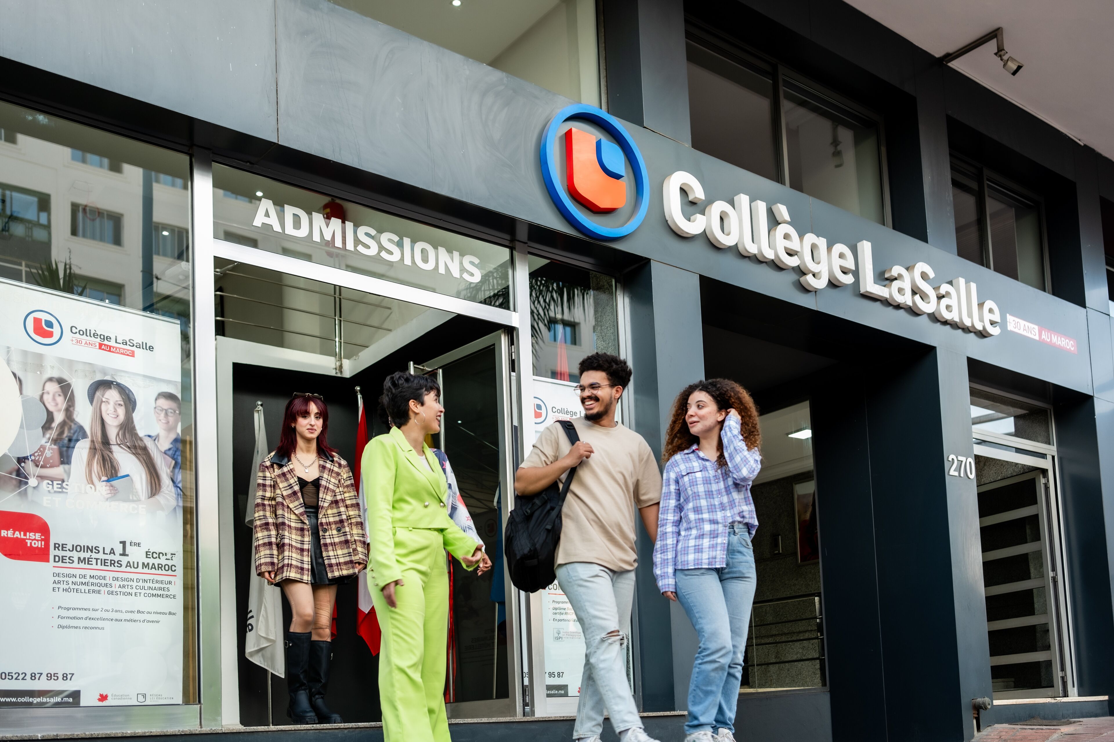 Four diverse students engaging in conversation outside the admissions entrance of Collège LaSalle.