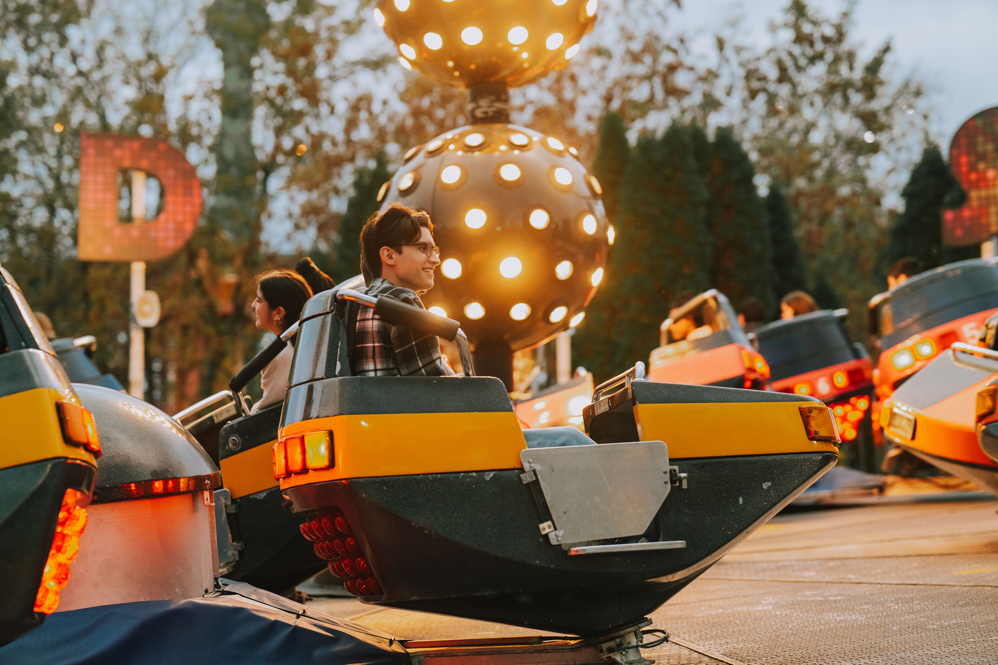 Joyful moments captured on bumper cars at dusk, with glowing lights and laughter in the air.