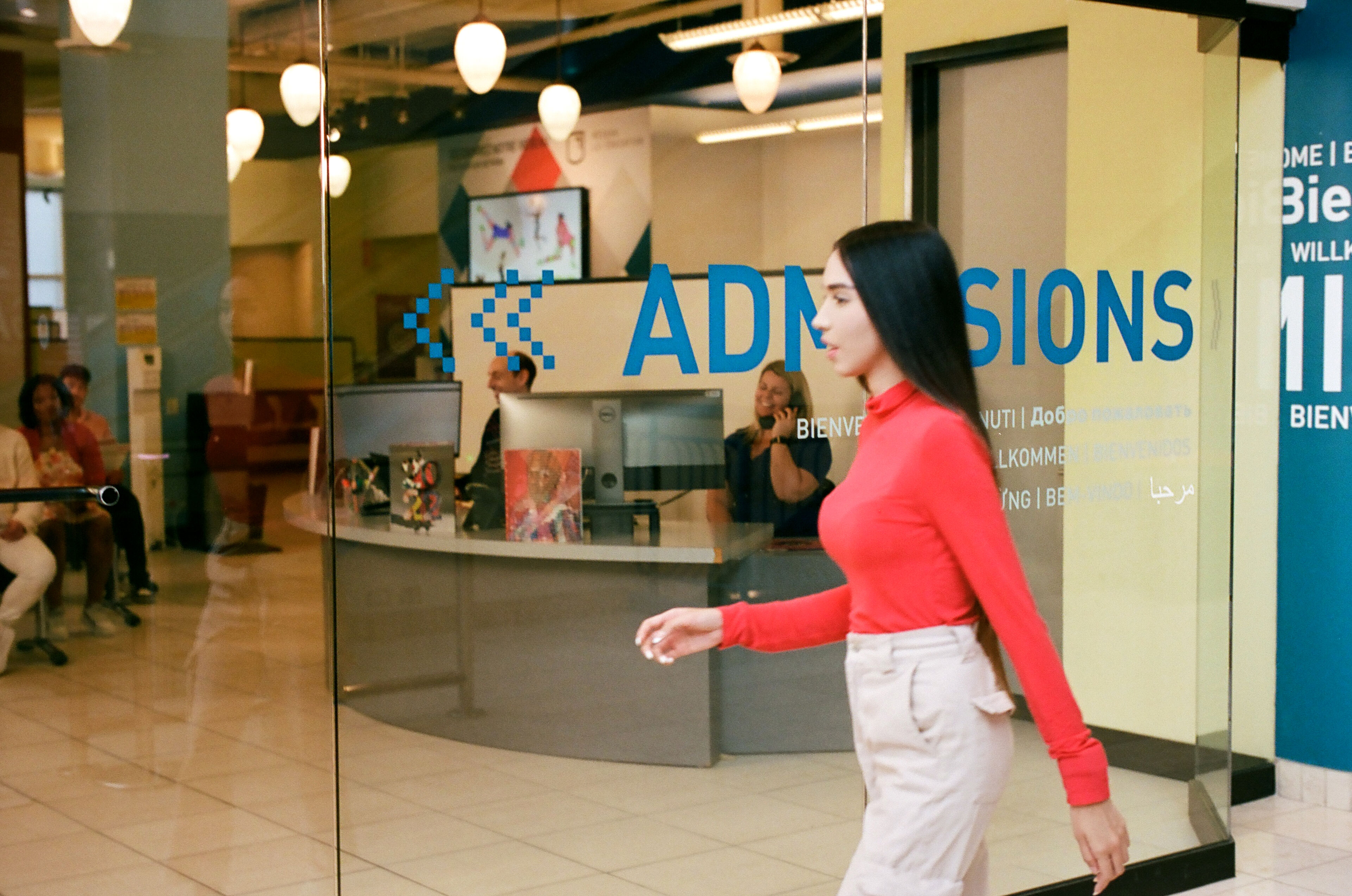 A student strides past the admissions office, a place of new starts and diverse opportunities.