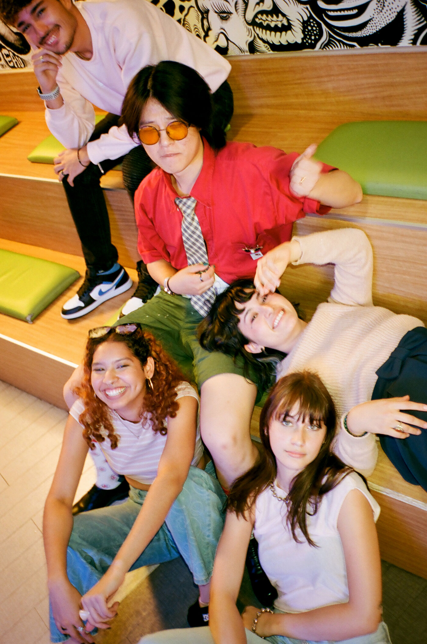A diverse group of friends poses playfully, showcasing their unique styles.