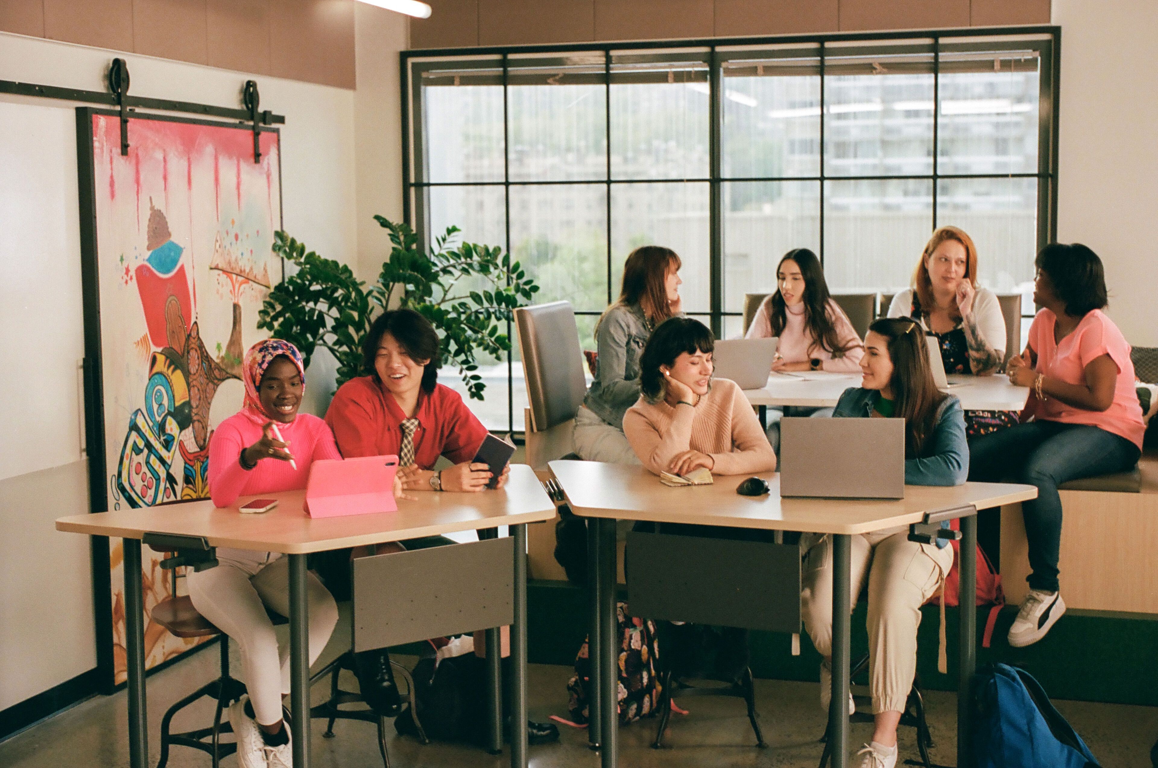 Diverse group of colleagues engage in creative discussion in a bright office.