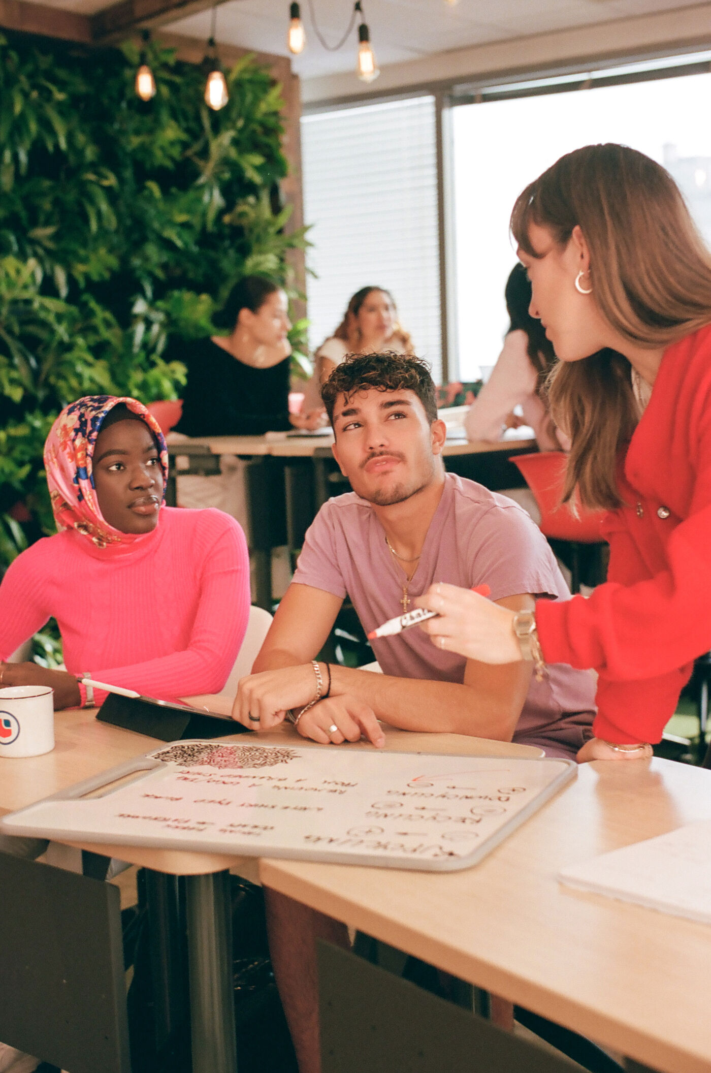 Students engage in a group discussion at a vibrant campus café.