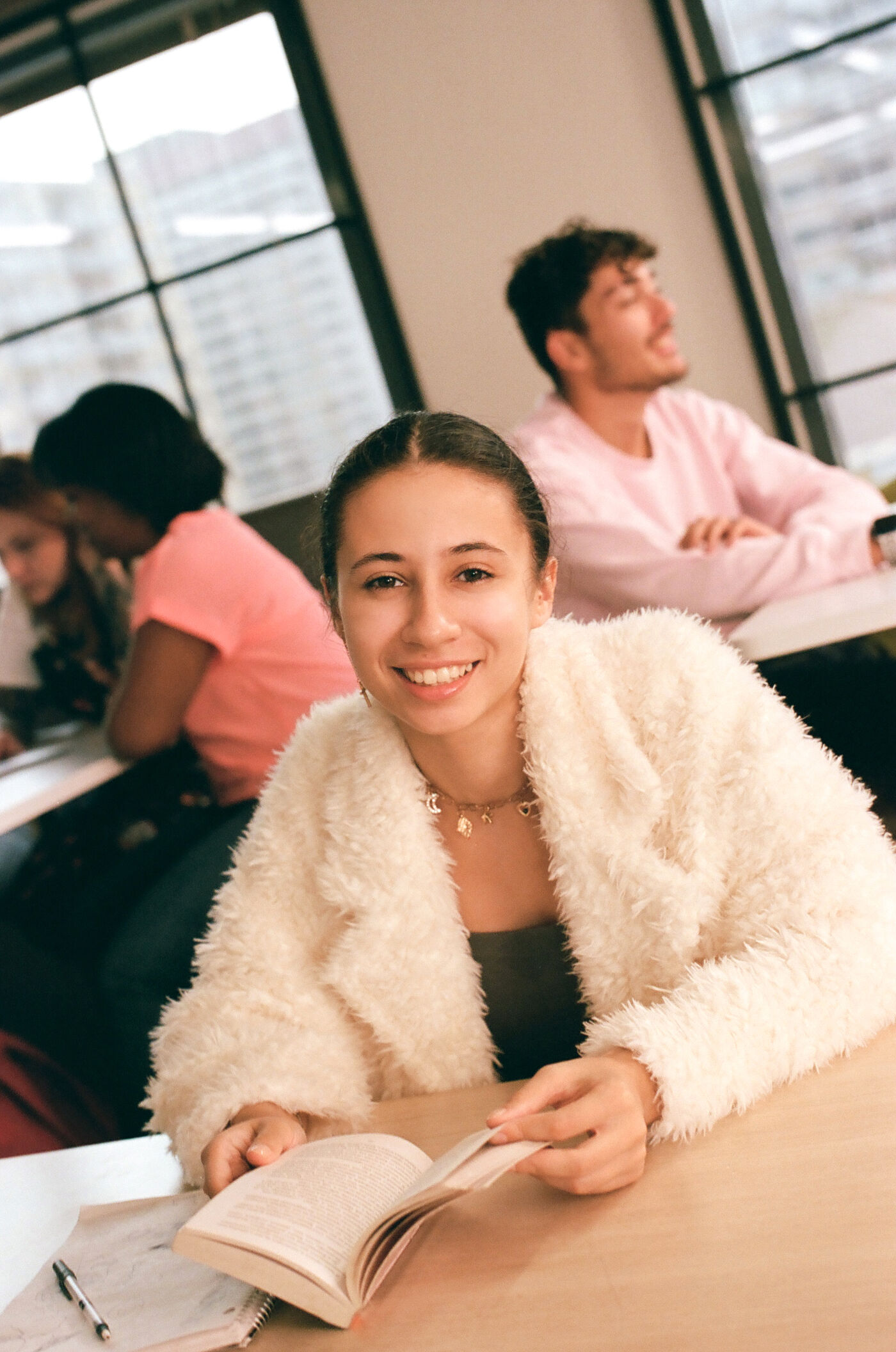 A student's smile captures the light-hearted atmosphere of a classroom in session.