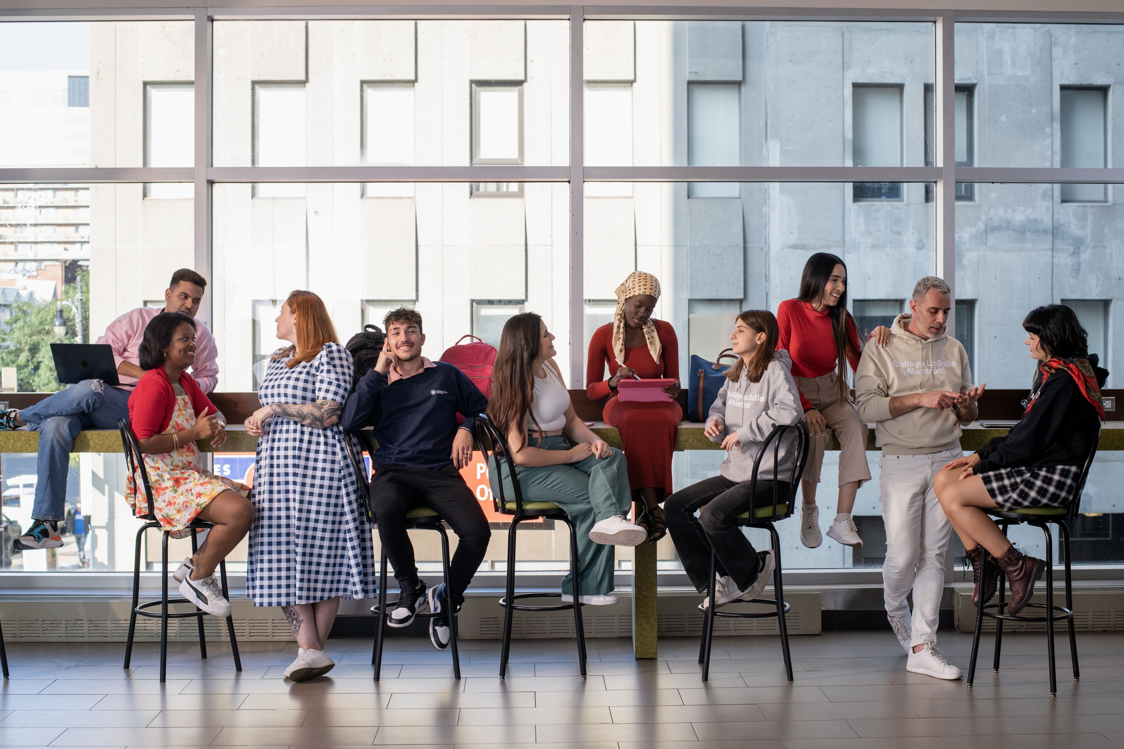 Students gather in a sunlit atrium, sharing thoughts and enjoying the camaraderie.