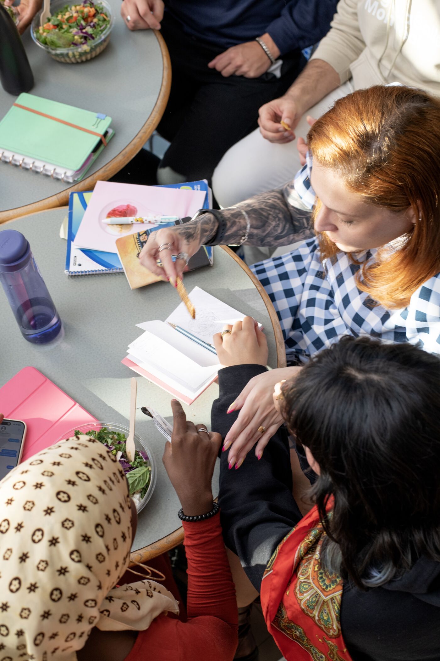 A focused group of students engage in a study session, surrounded by books and notes.