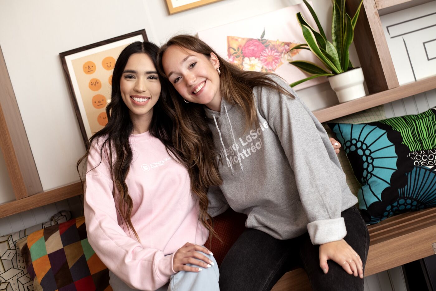 Two students share a moment of joy, surrounded by a warm and inviting study environment.