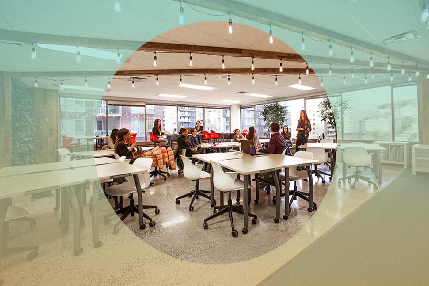 A contemporary classroom setting with individual tables and chairs, large windows, and a group of students engaged in a lecture.