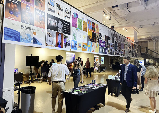 An exhibition space filled with a tapestry of artistic posters reflecting student innovation.