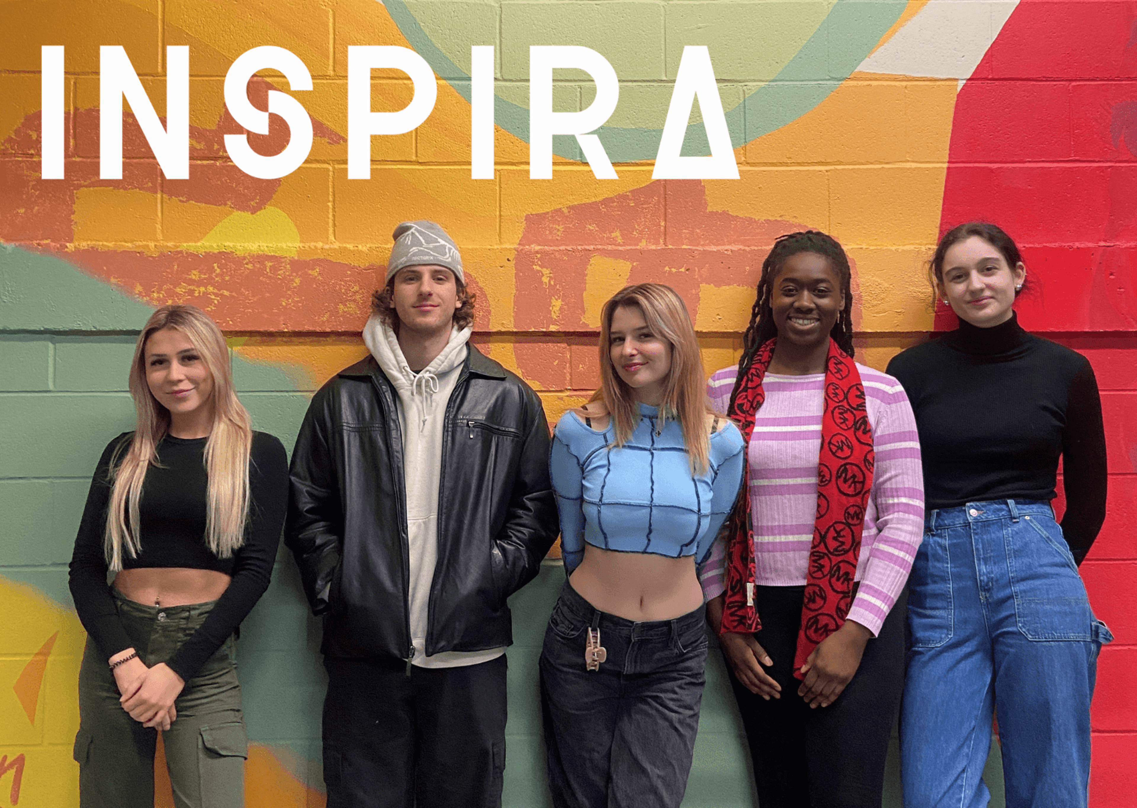 A diverse group of young adults standing confidently in front of a colorful mural, embodying youthful inspiration.