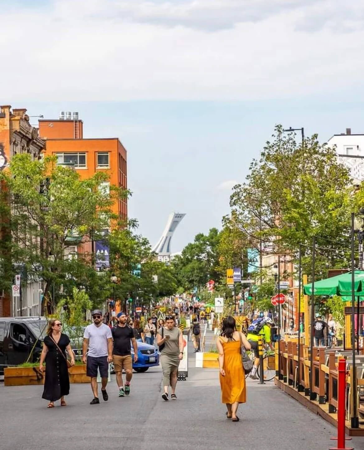 Bustling City Street with Olympic Stadium in the Background