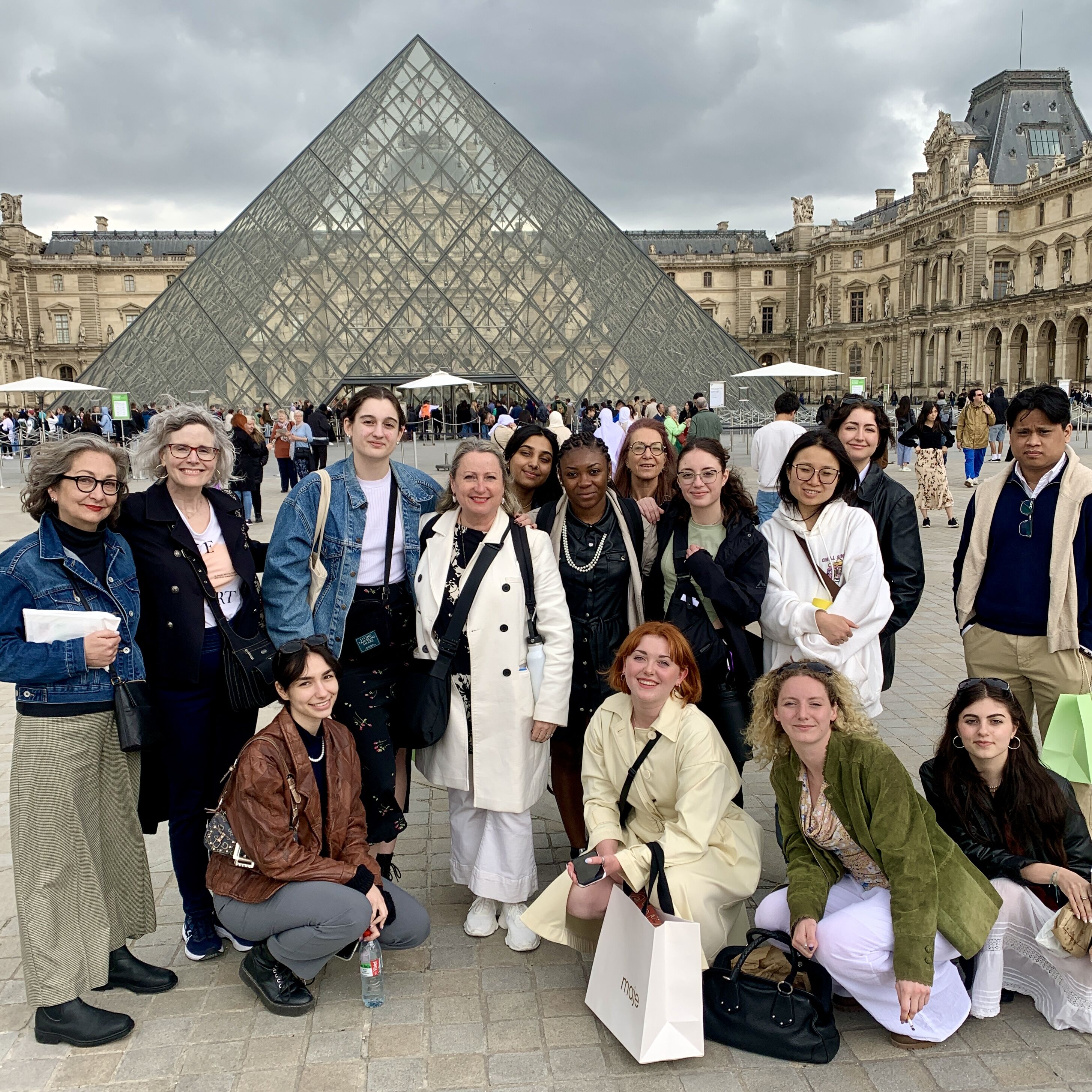 Group of Tourists at the Louvre Pyramid