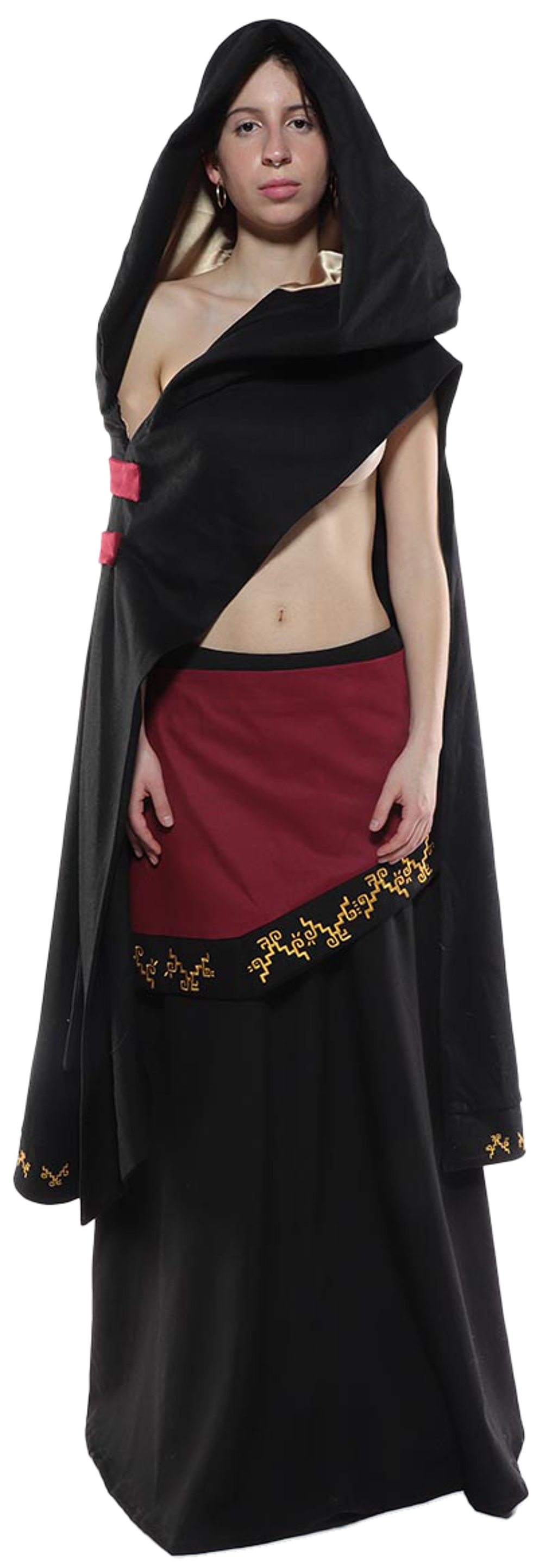 A woman with bare shoulders wears a long black hooded cloak over a maroon skirt with gold embroidery, standing against a white background.