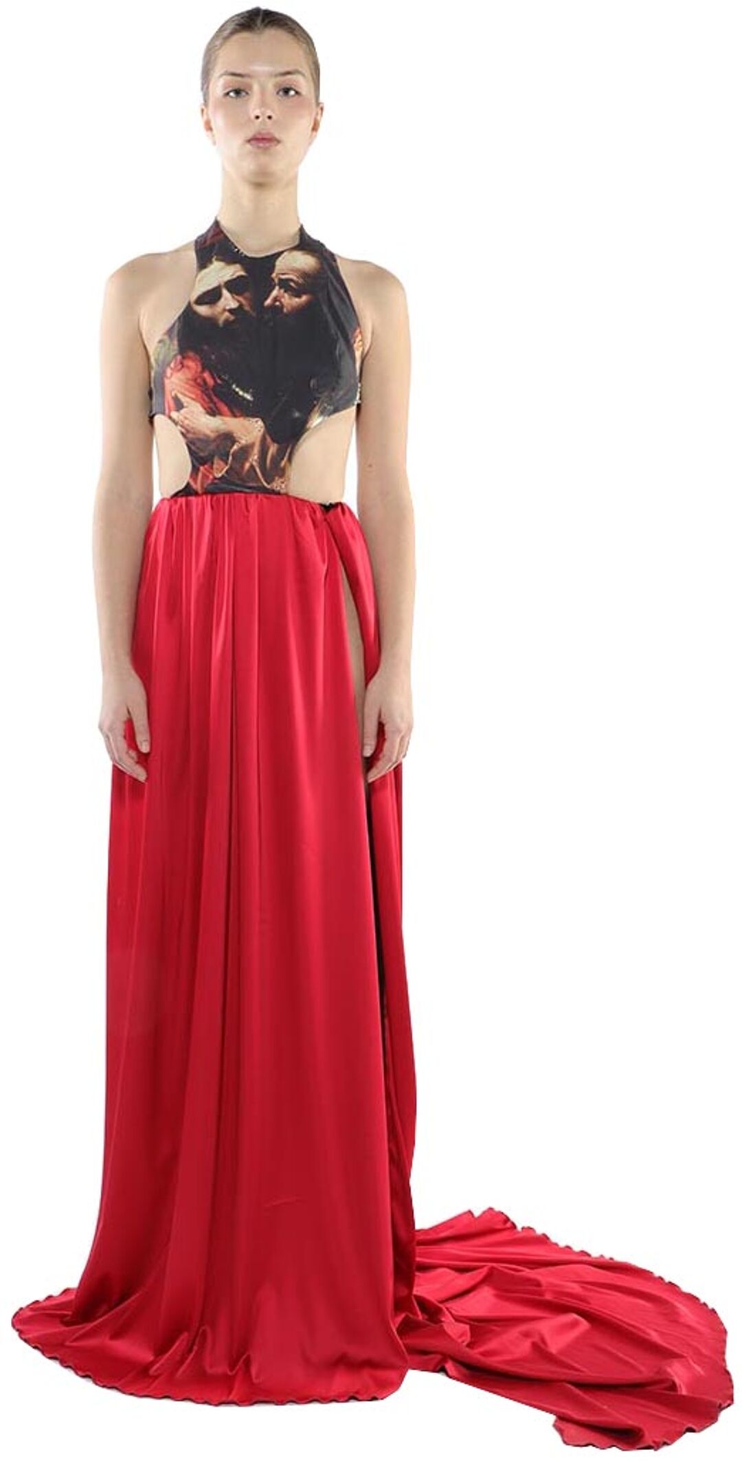 A woman in a red satin maxi dress with a halter top featuring a painting of two men stands against a white background.