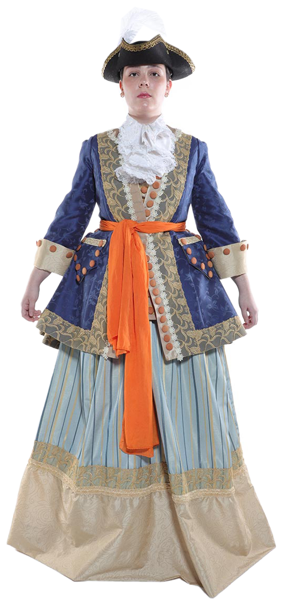 A woman in a blue and gold brocade coat, a white lace collar, an orange sash, and a striped skirt stands against a white background, wearing a tricorn hat with a white feather.