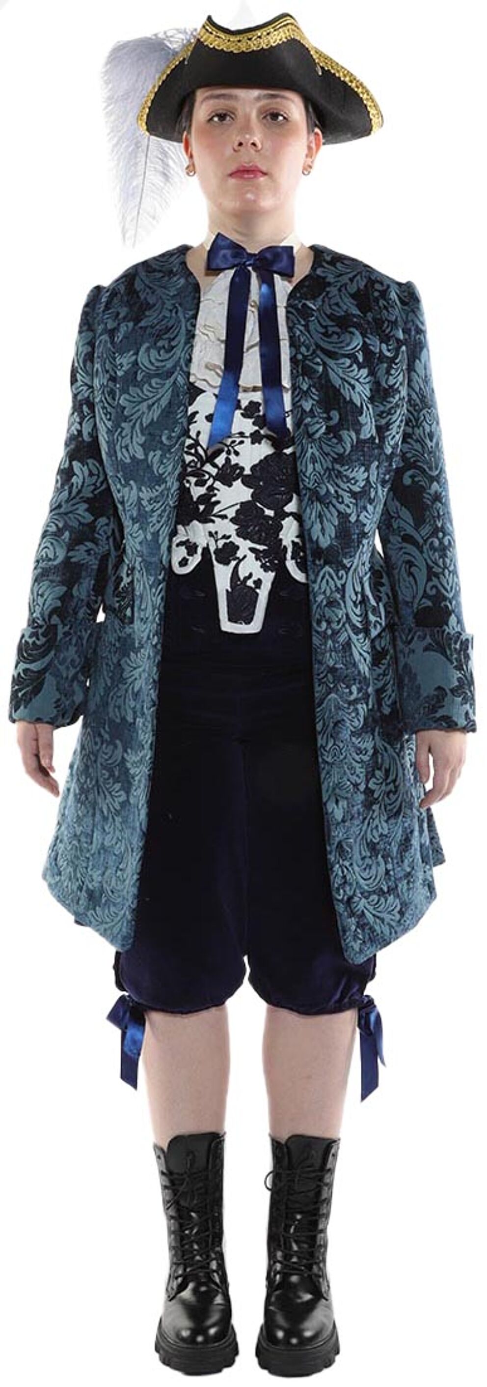 A person wearing a teal brocade coat, dark breeches, boots, and a tricorn hat stands against a white background.