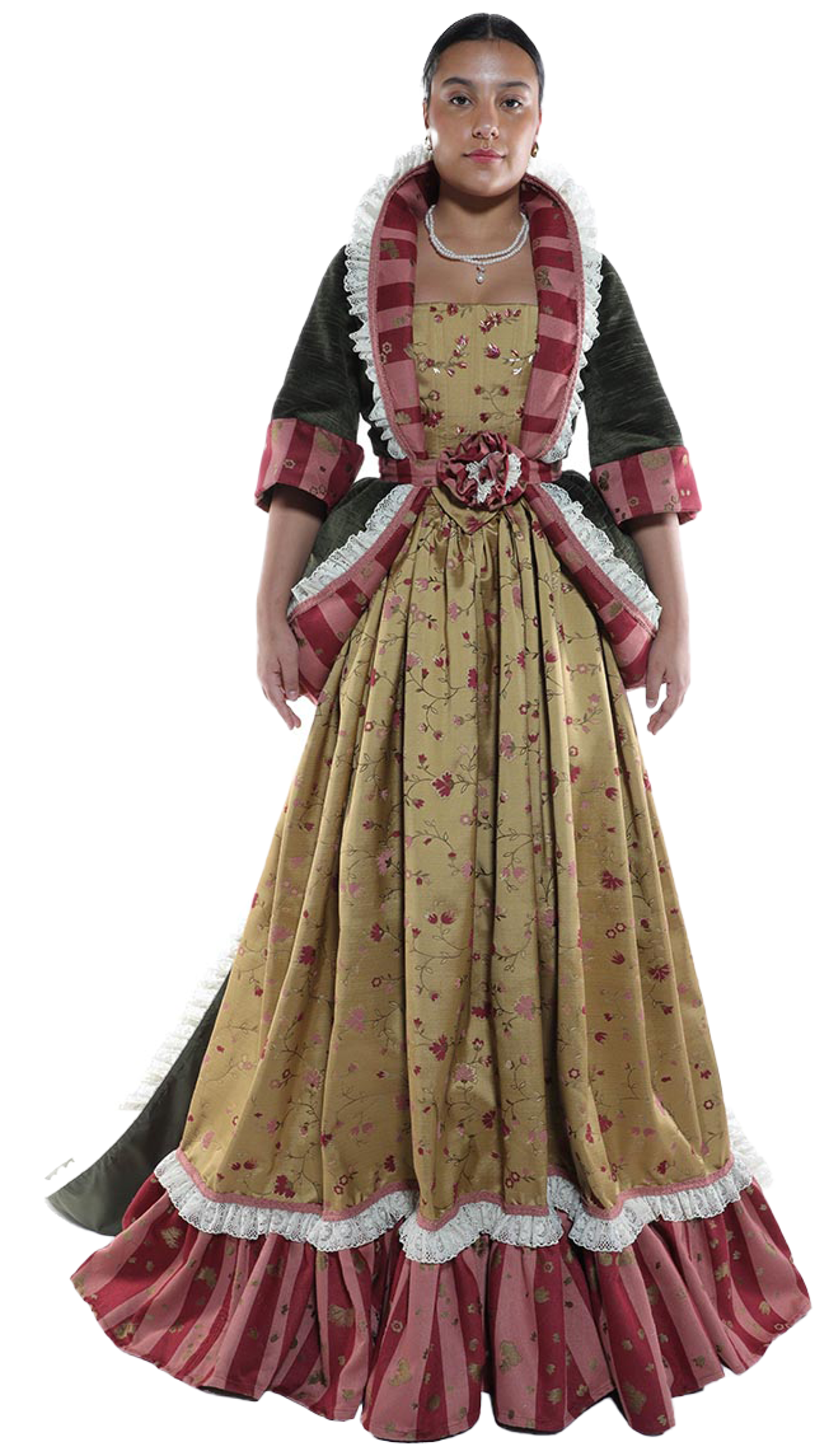 A young woman with dark hair pulled back stands against a white background wearing a long, elaborate gown with a gold brocade bodice and skirt, a dark green jacket with pink and gold striped sleeves, and a white lace trim.