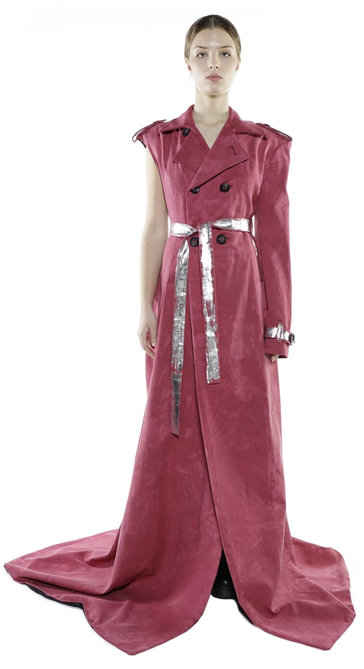 A model poses in a dusty rose, one-sleeved maxi dress with a silver belt.