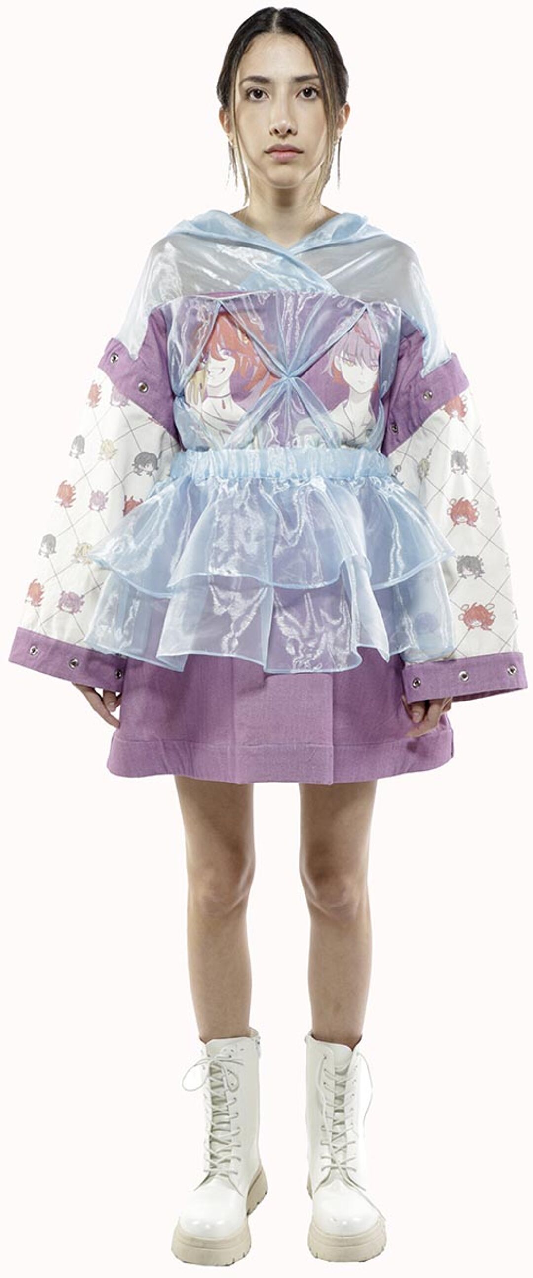 A young woman with dark hair pulled back in a ponytail models a lavender and light blue layered jacket with a sheer overlay and matching skirt, paired with white lace-up boots.