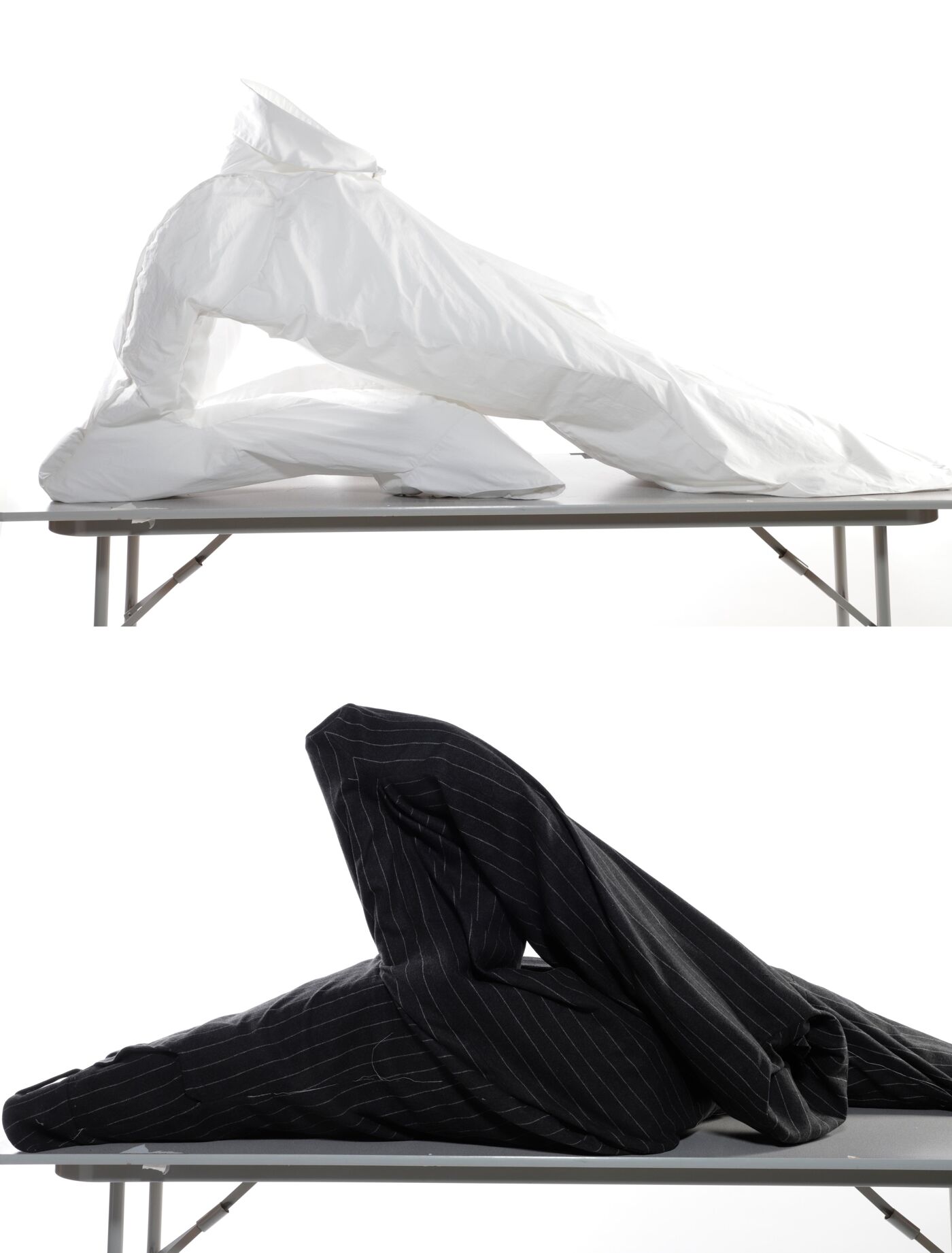 High-angle, full shot of two images showcasing a white duvet cover and a black pinstripe duvet cover haphazardly draped over a simple metal folding table.