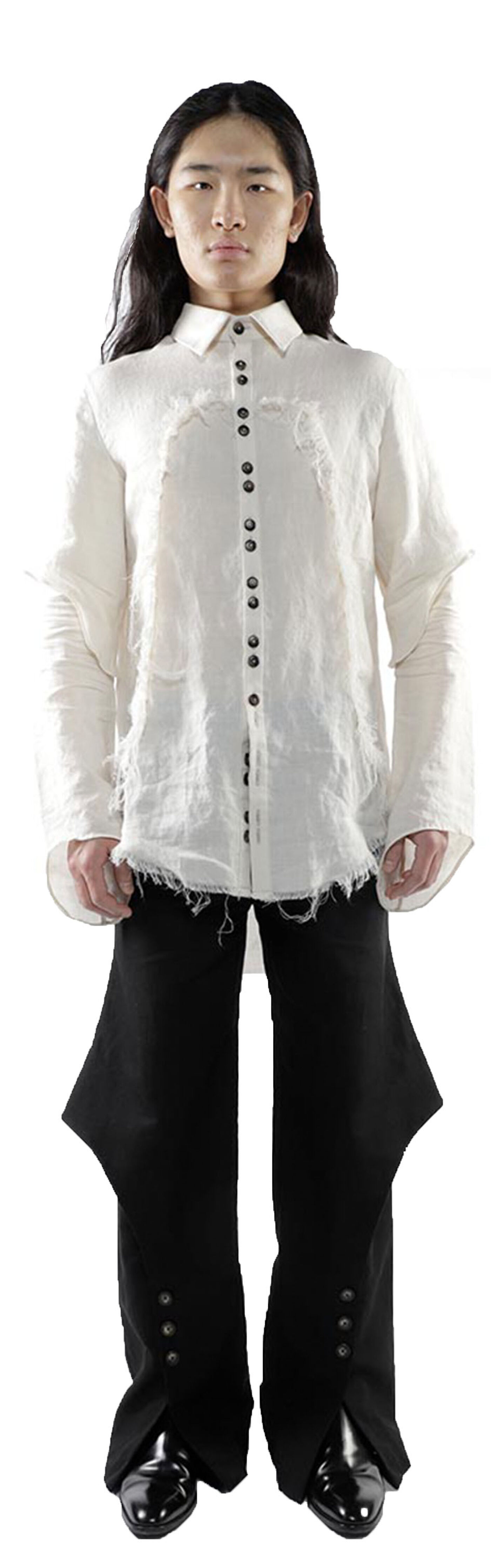 A person with long dark hair wears a distressed off-white long-sleeve button-up shirt and black pants with buttons on the sides, standing against a white background.