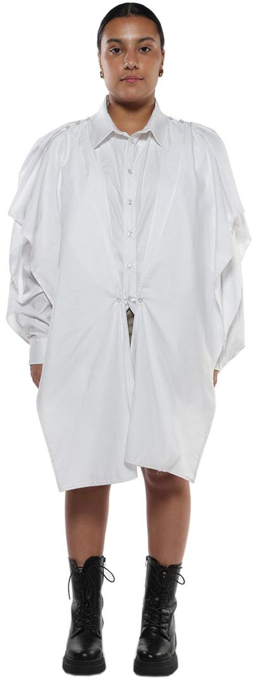 A woman models a white, oversized collared shirt dress with puffy sleeves, cinched at the waist, paired with black lace-up combat boots.