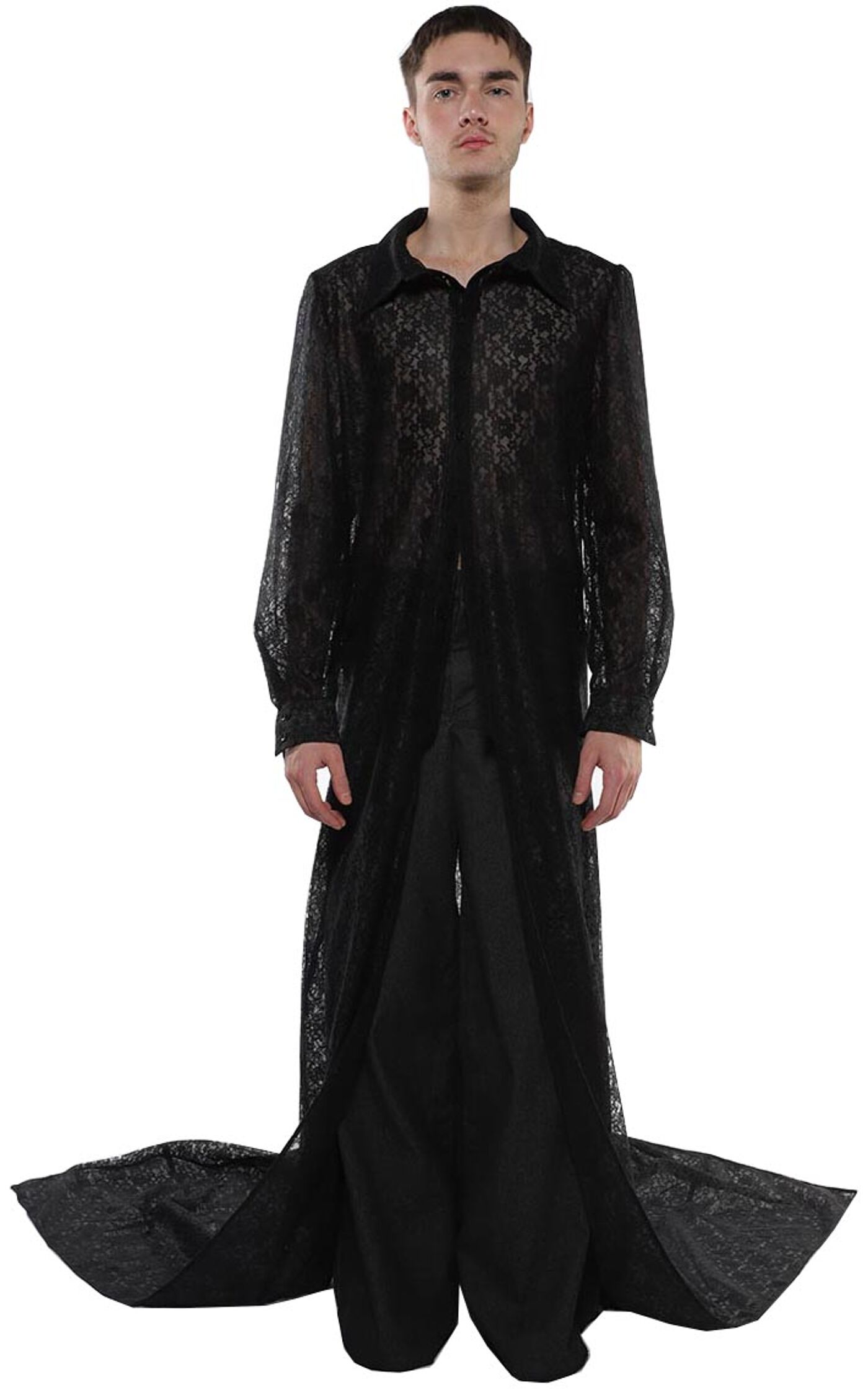 A person with short brown hair is modeling a long, black, lace shirt with a train.