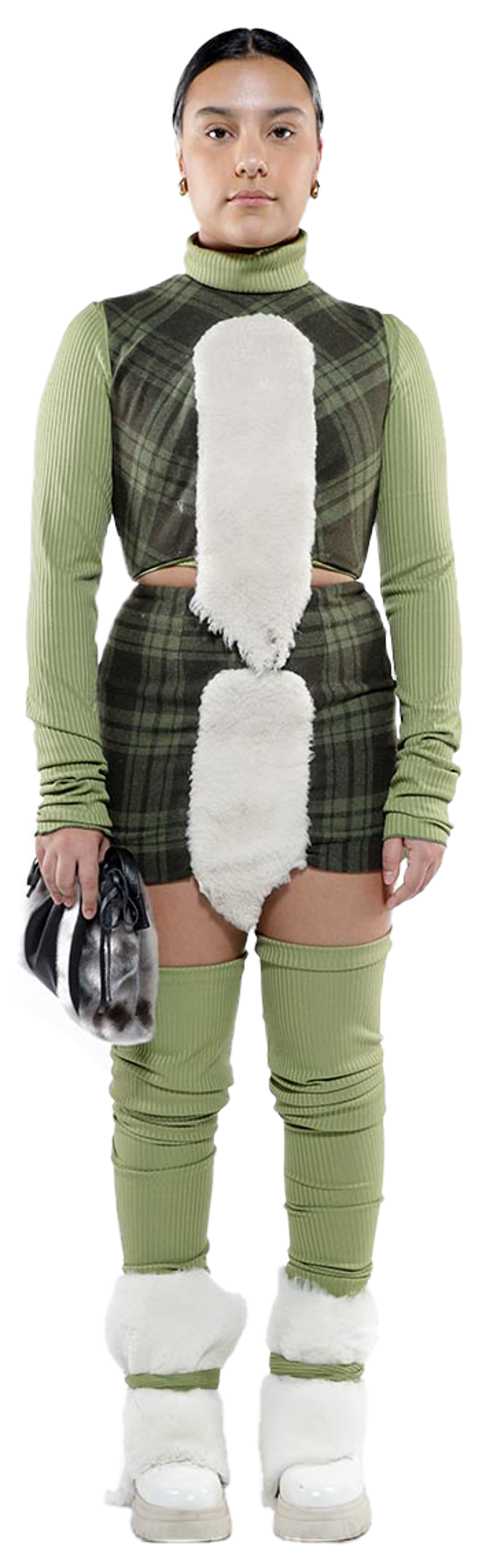 A person wearing a green plaid and white fur outfit stands against a white background.