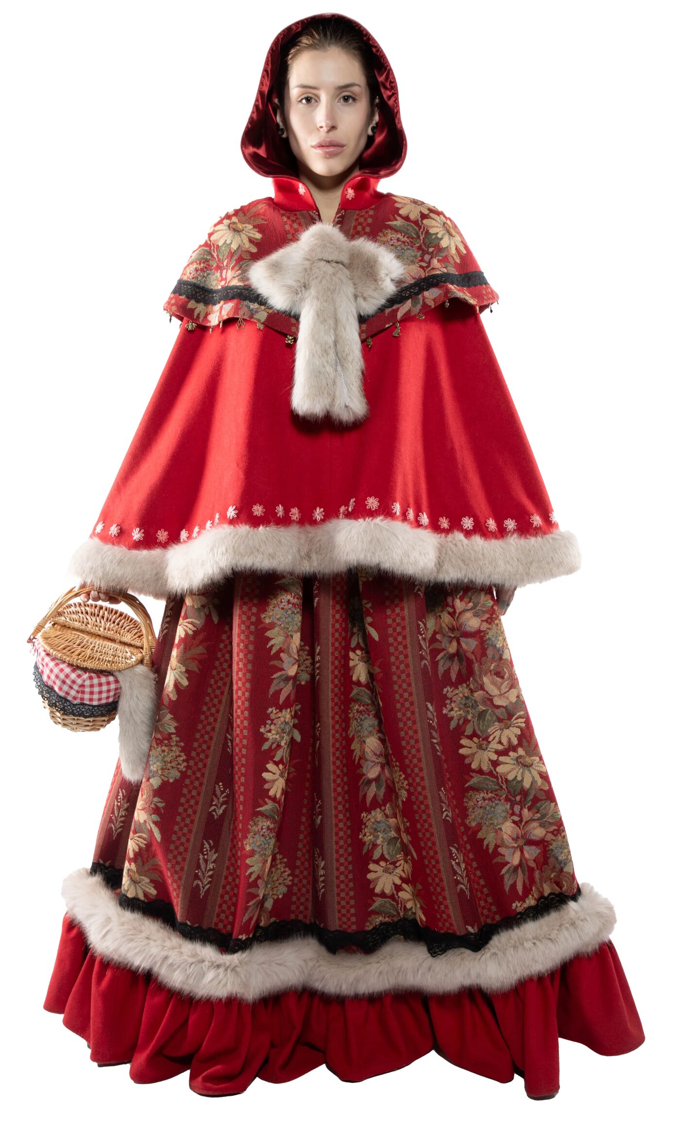 A woman in a red hooded cloak and matching floral gown with fur trim holds a small wicker basket.