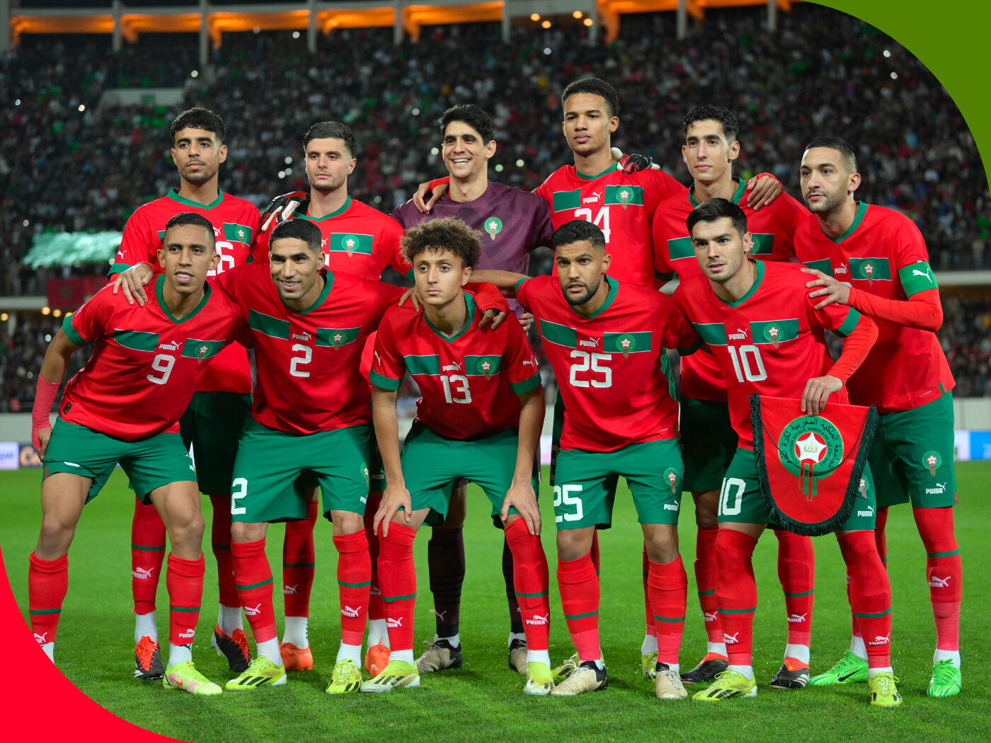 The image features a soccer team posing for a group photo. The team is standing together on a soccer field, and they are wearing their uniforms.