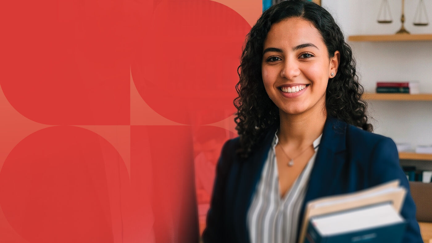 A smiling woman in a dark jacket carries books, set against a red background with circles. She appears to be a lawyer or a student.