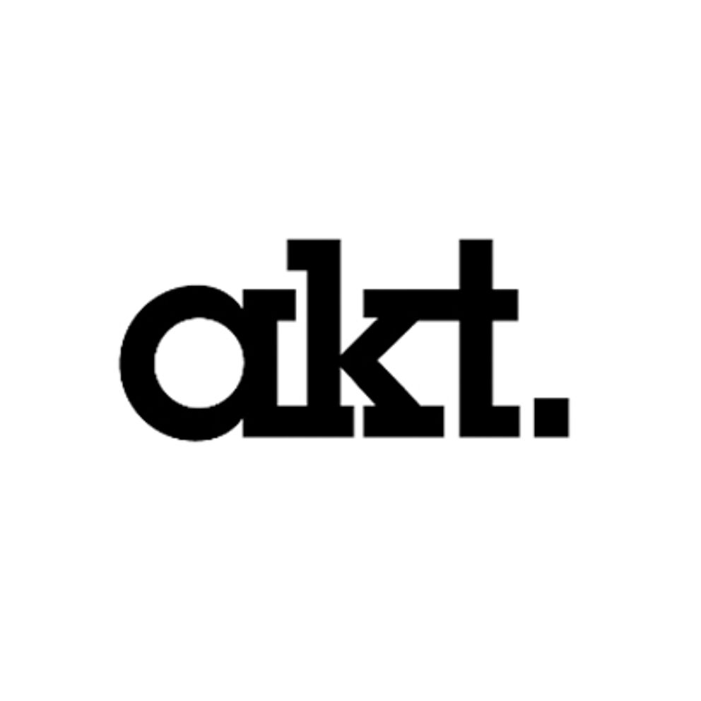 he image shows a minimalist black text logo reading "akt." with a period, using a bold, sans-serif typeface on a white background.