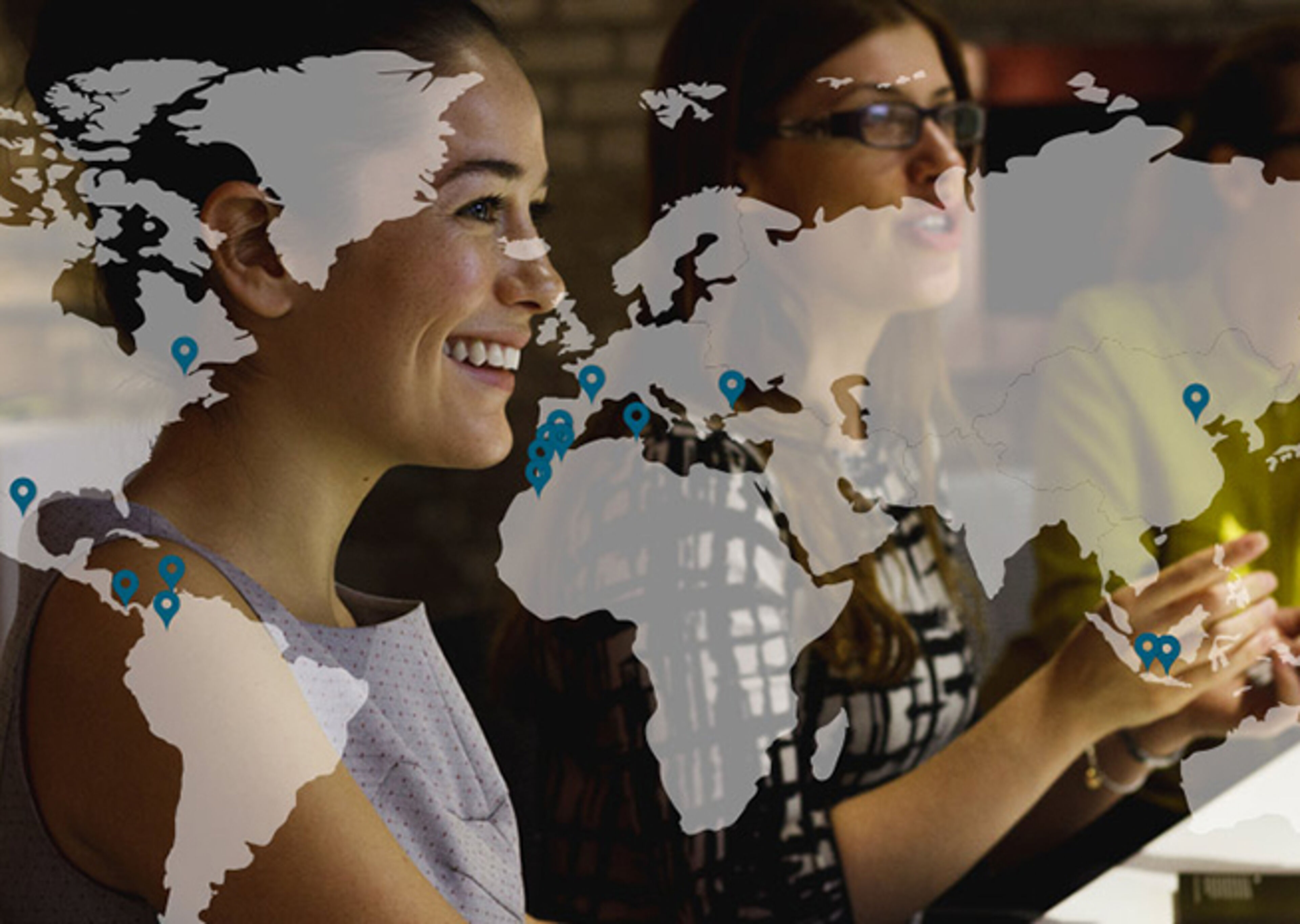 Image overlaying a world map with connection icons on a photo of two smiling women, symbolizing global collaboration.