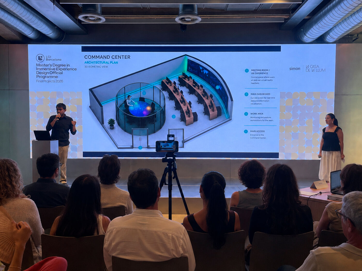 A presentation about a command center, featuring a detailed visual display and speakers engaging with the audience.