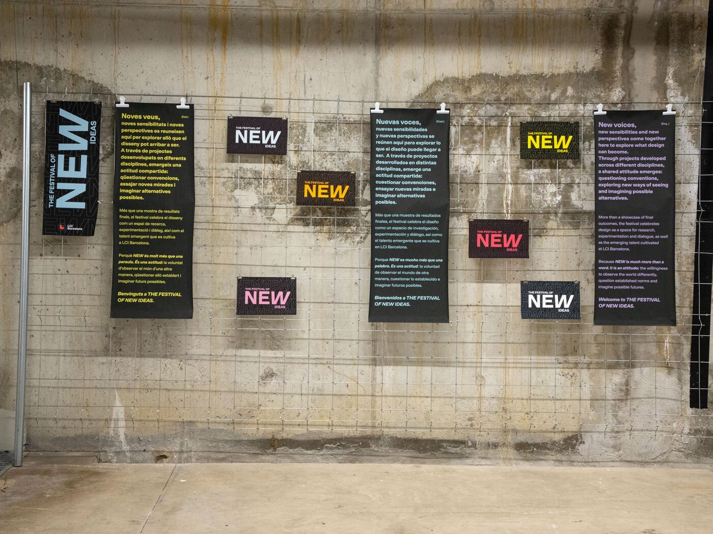 Promotional image for NEW'26 – The Festival of New Ideas, featuring a gallery-style display of event posters arranged on a concrete wall.