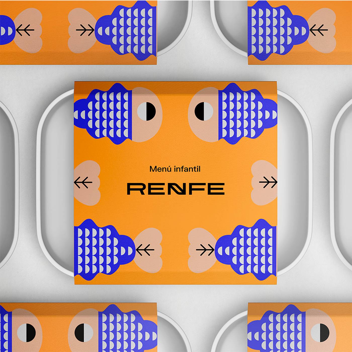 A close-up shot shows several white rectangular trays with orange and blue children's menu packaging that features a repeating pattern and the RENFE logo.