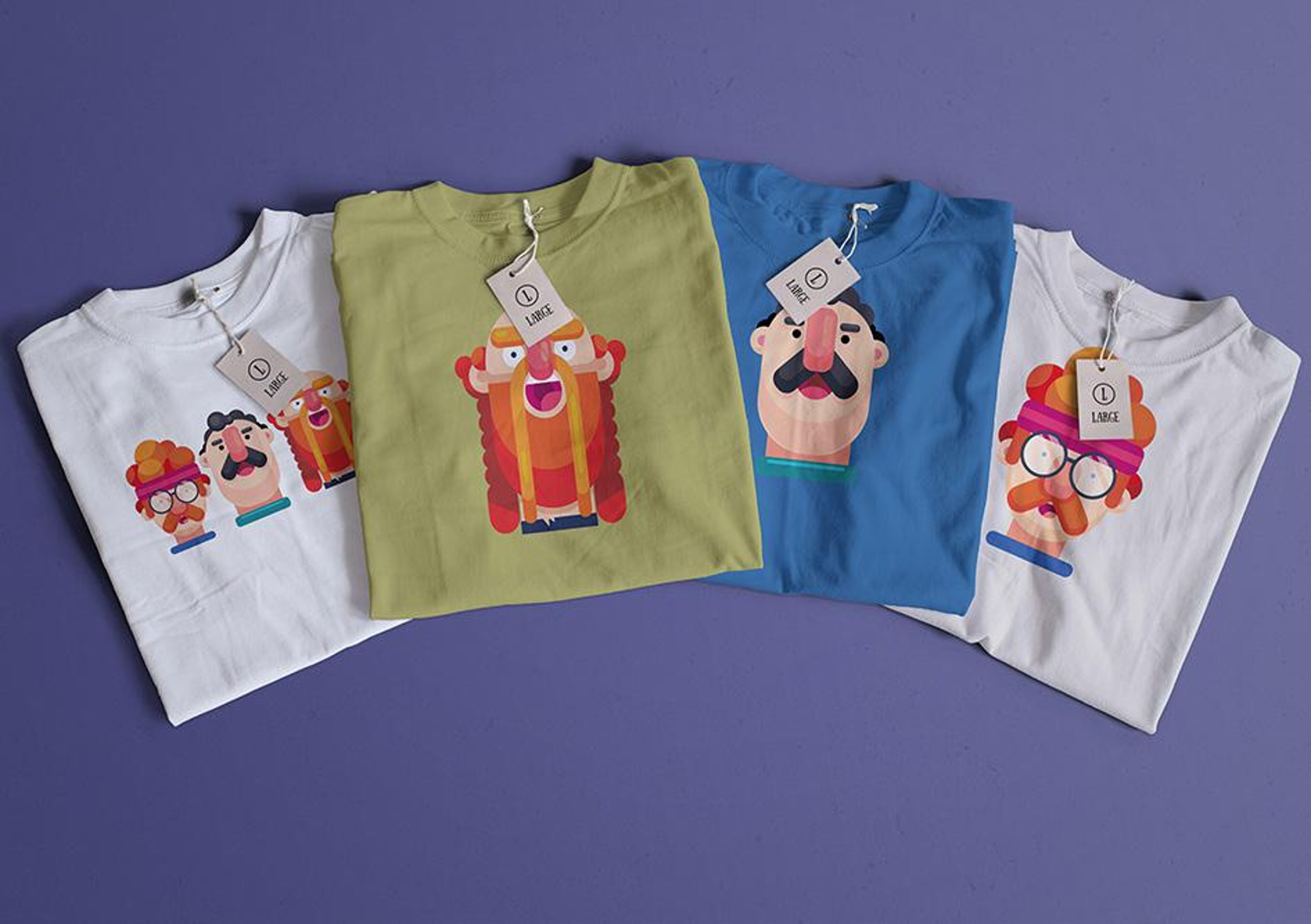 A collection of four t-shirts with playful cartoon prints, spread on a purple surface.