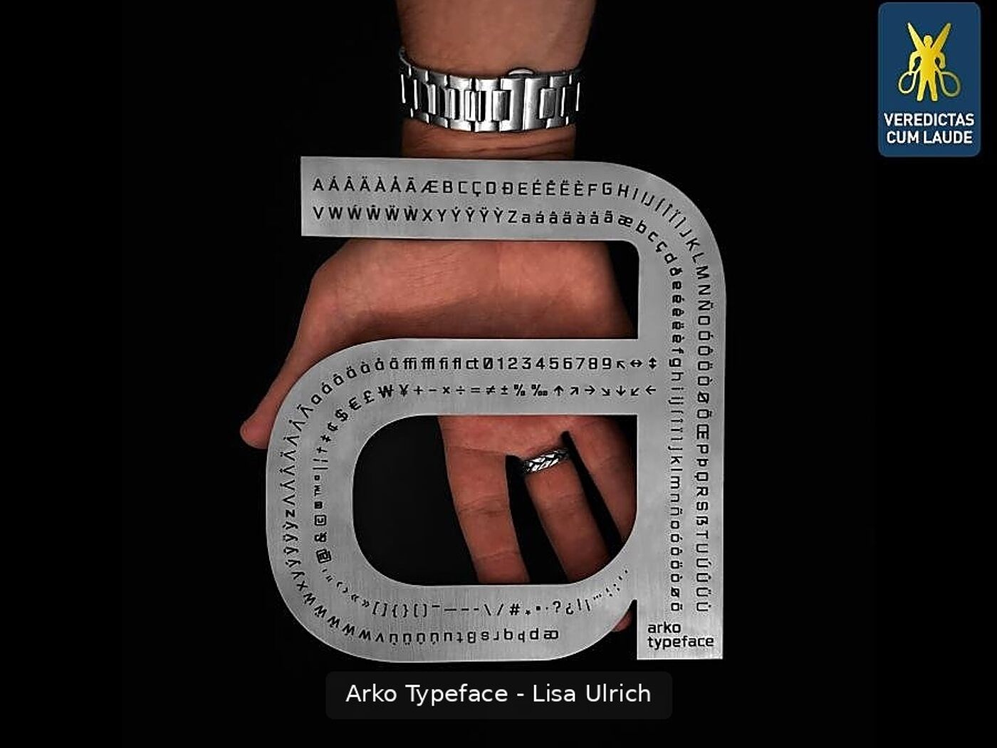 This image showcases the Arko typeface by Lisa Ulrich, featuring a metallic design with characters, symbols, and numbers. It is presented against a black background.