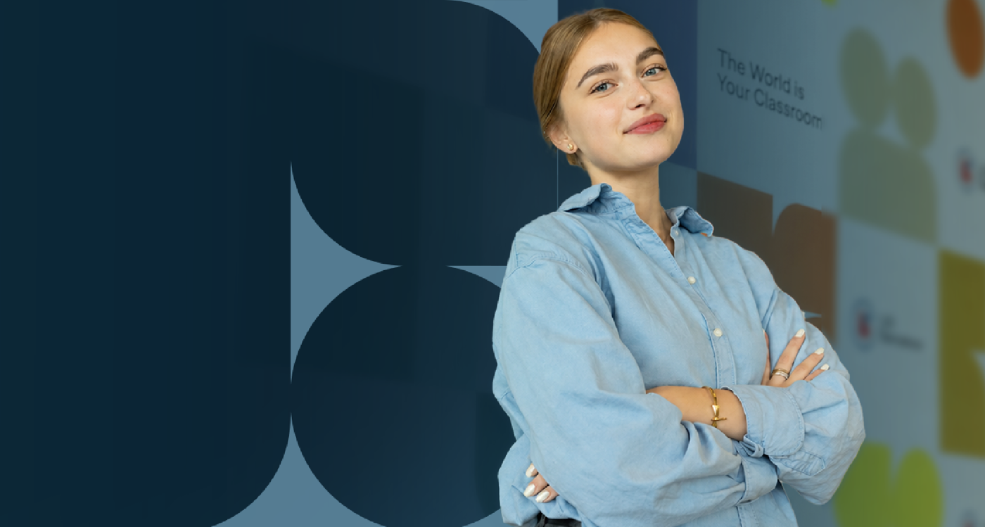 A young woman with her arms crossed looks confidently at the camera. The image features a blue background with circles and text that reads 'The World is Your Classroom'.