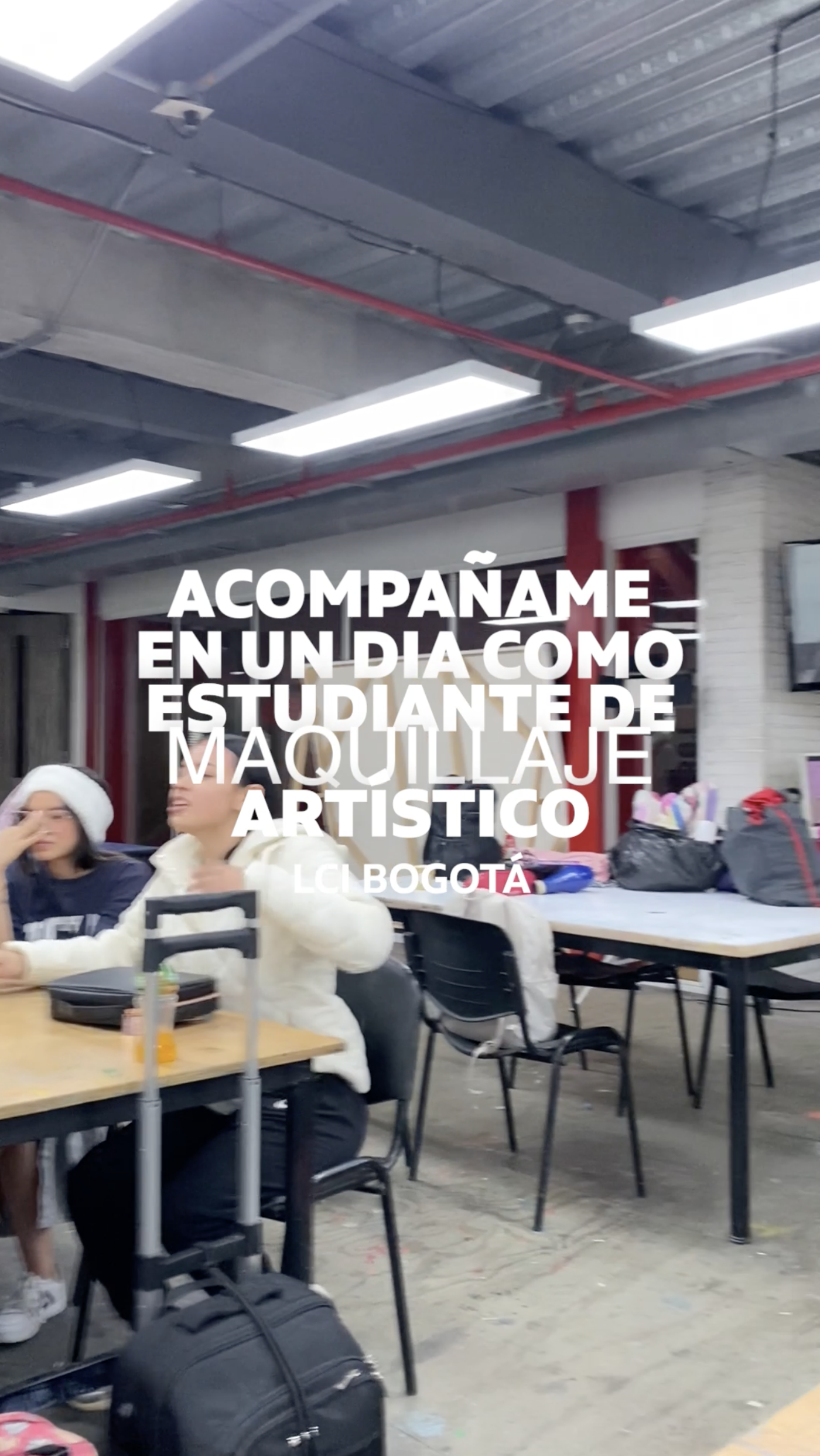 A video shows a classroom setting with students seated at tables, along with text overlay in Spanish that translates to "Join me for a day as an artistic makeup student, LCI Bogota".