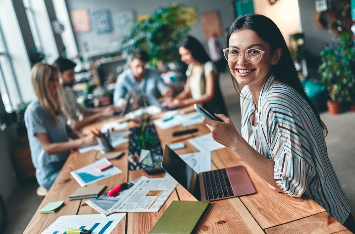 Group of young business people are working together in modern office. Creative people with laptop, tablet, smart phone, notebook. Successful hipster team in coworking. Freelancers.