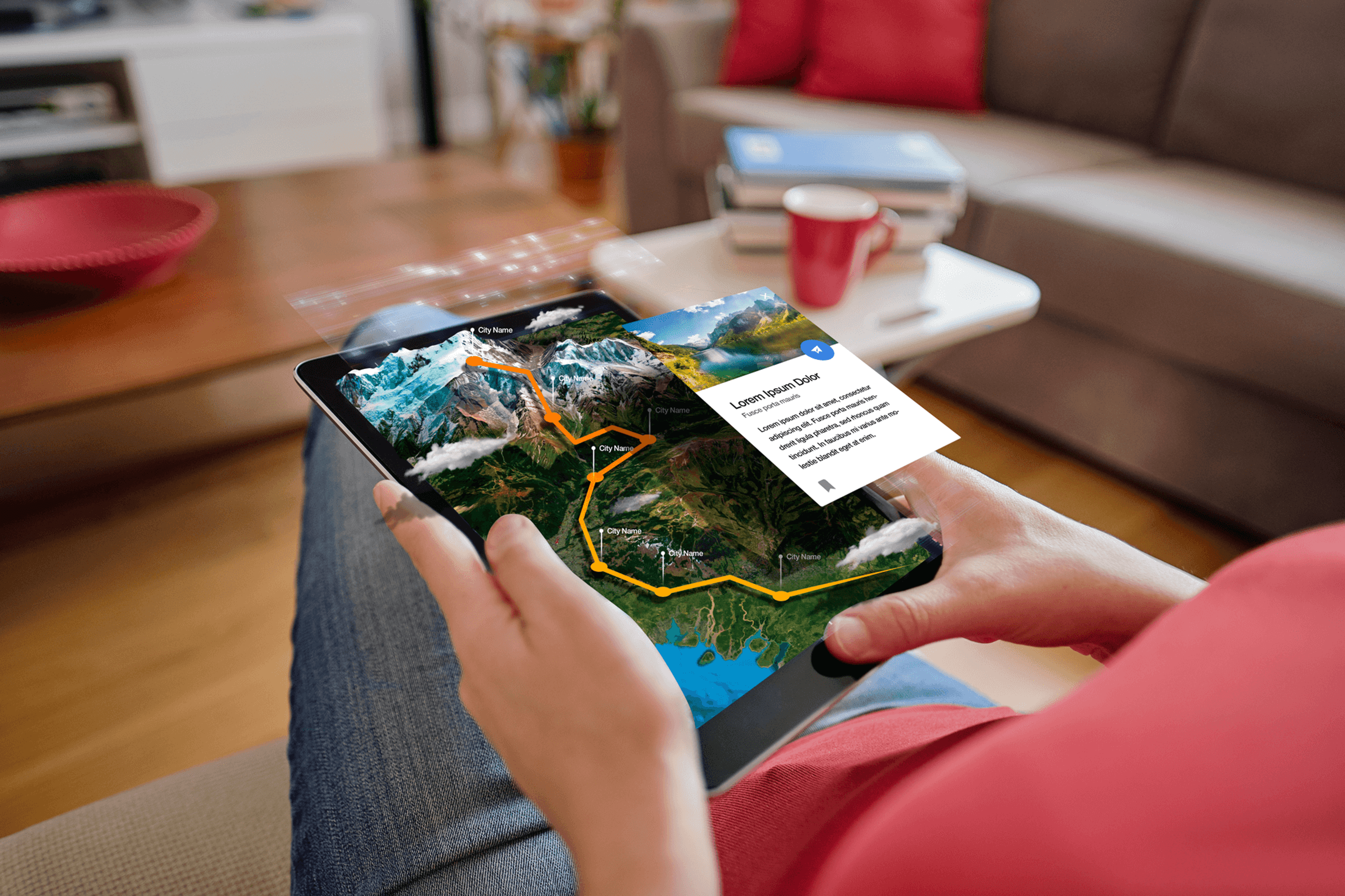 Hands holding a tablet displaying a 3D mountain range for an interactive virtual tour.