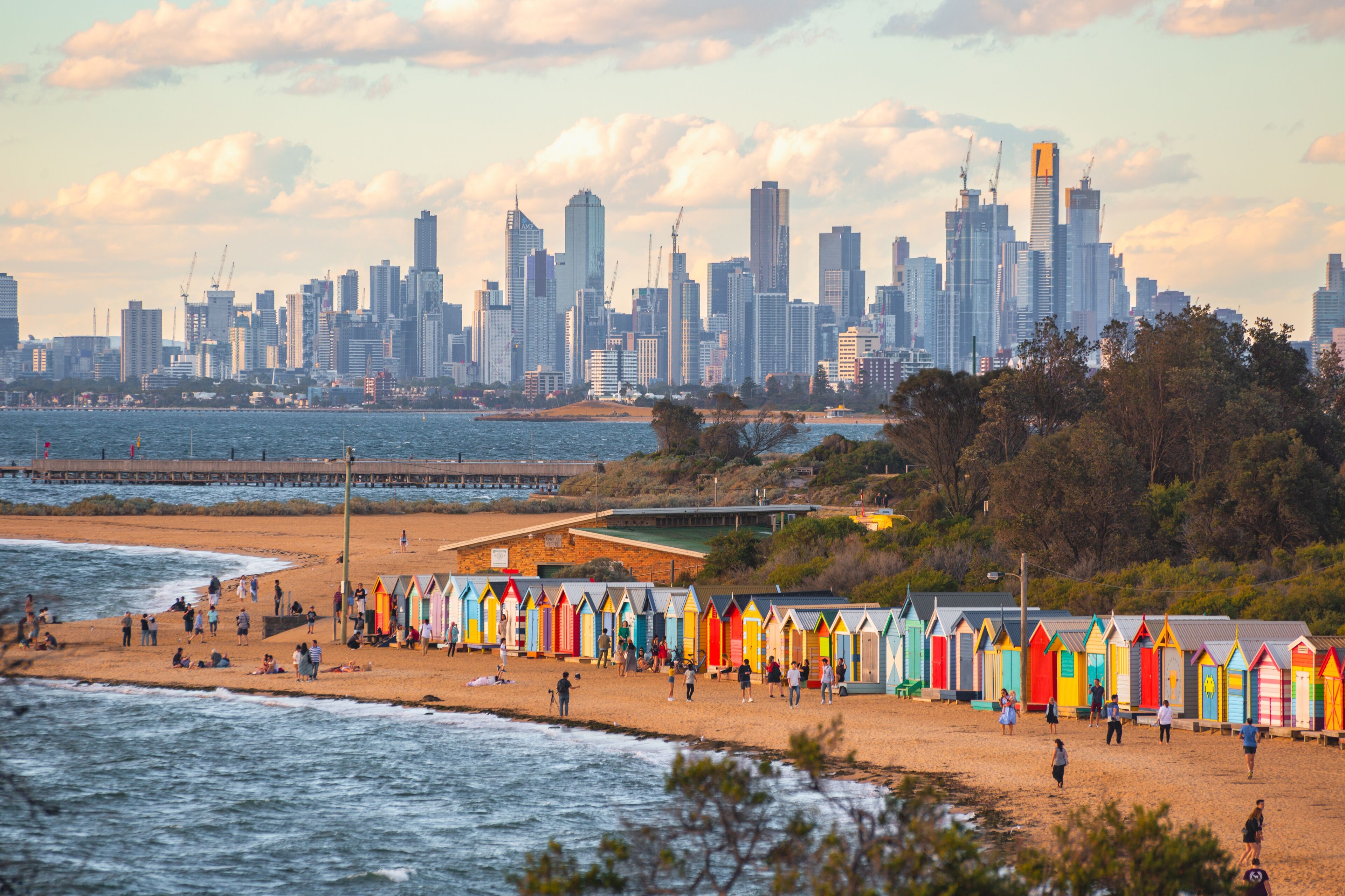 View of the beach of Brighton bathing boxes and on the horizon the Melbourne skylines