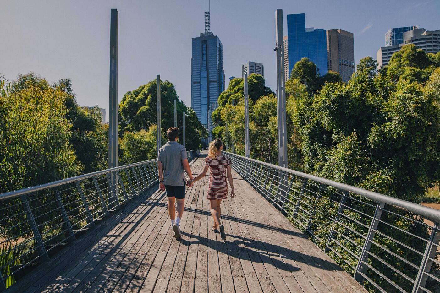 Young couple walking through Birrarung Marr in Melbourne, Australia.