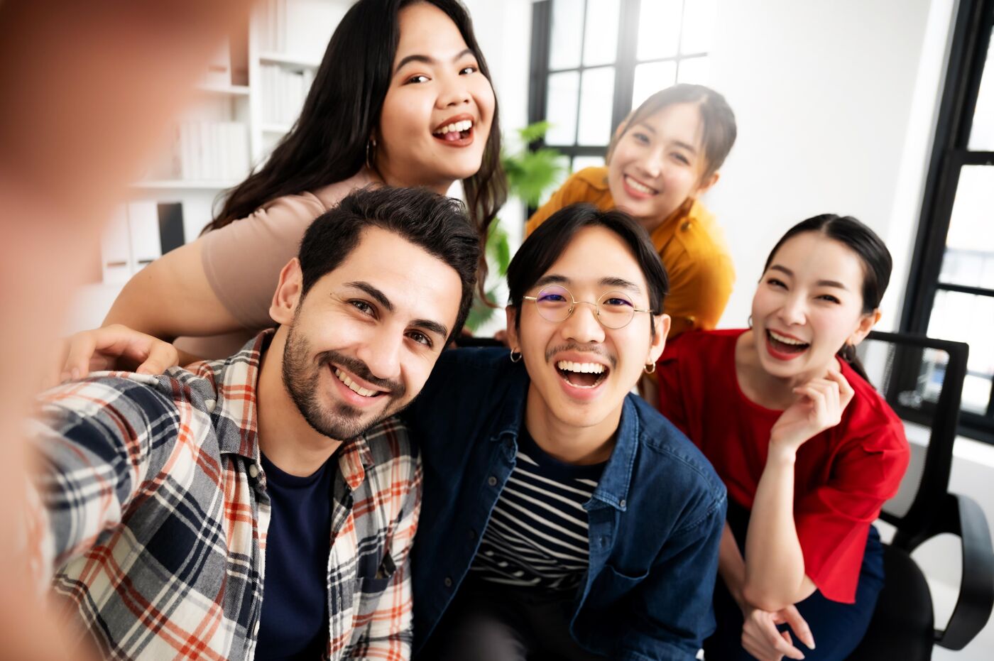 Selfie of group young man and woman team smiling having fun together
