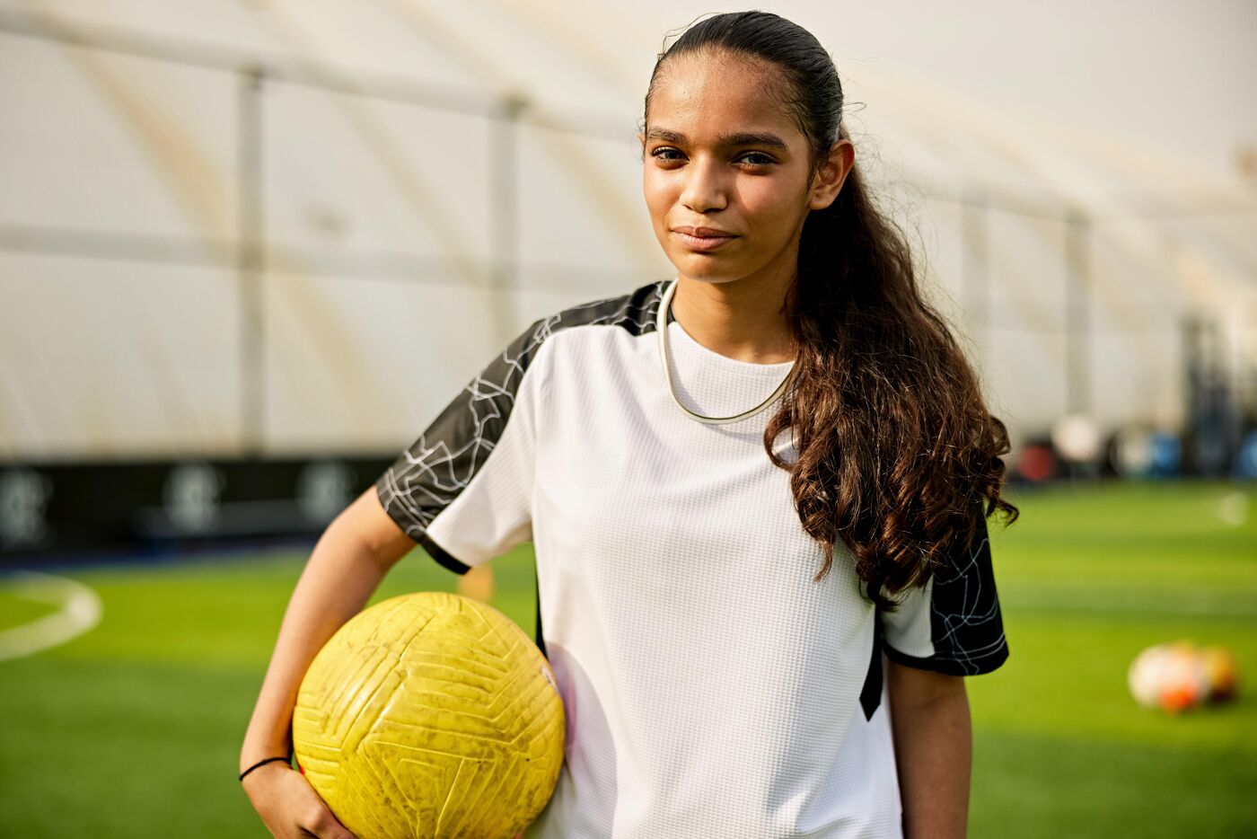 Longhaired Saudi footballer at sports complex