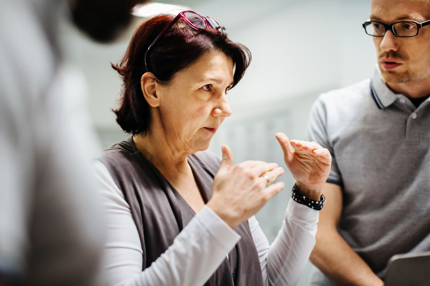 Mature businesswoman and manager of a printery briefing stuff during a meeting