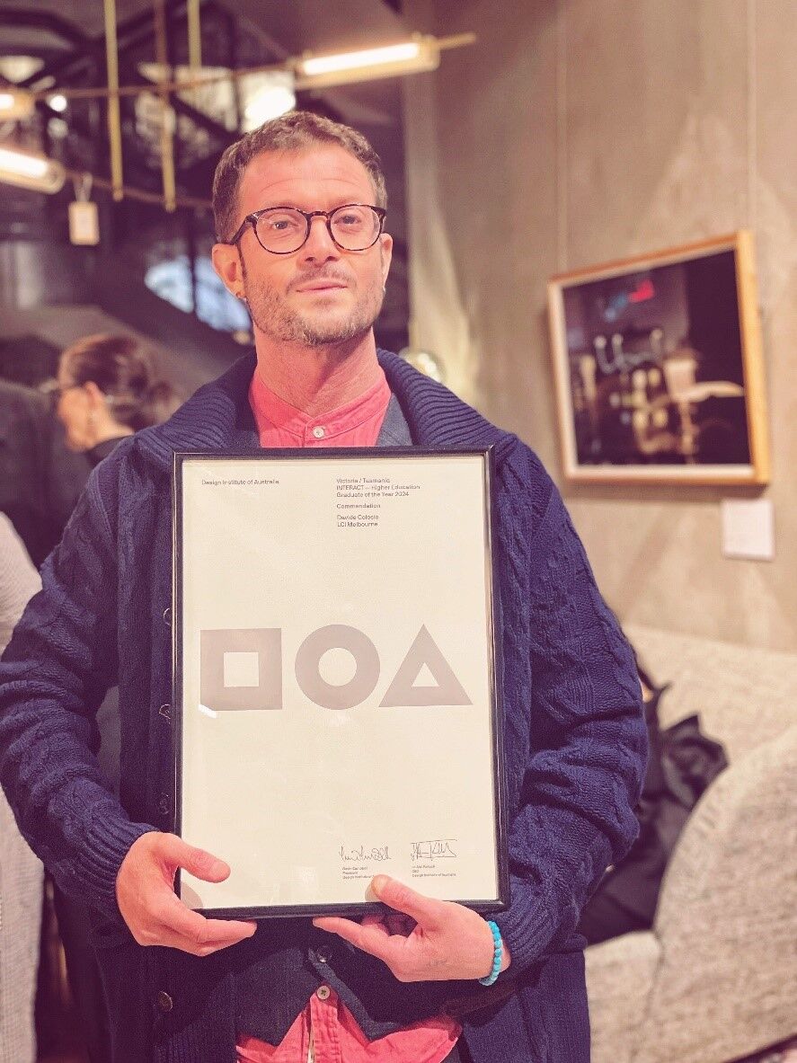 Man Holding Design Award Certificate