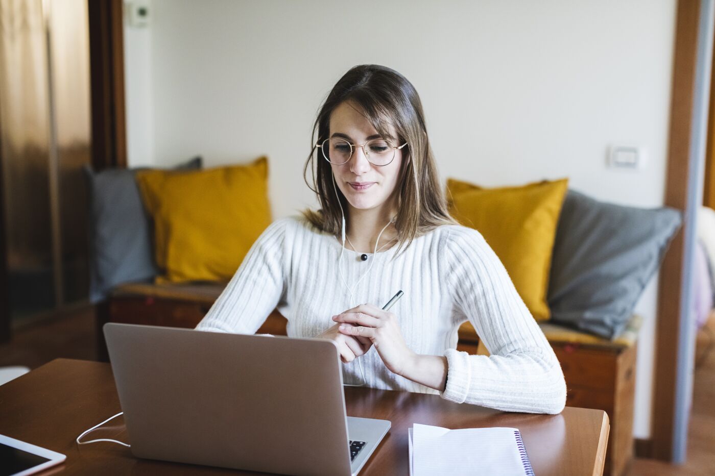 Student woman during E-Learning on laptop at home